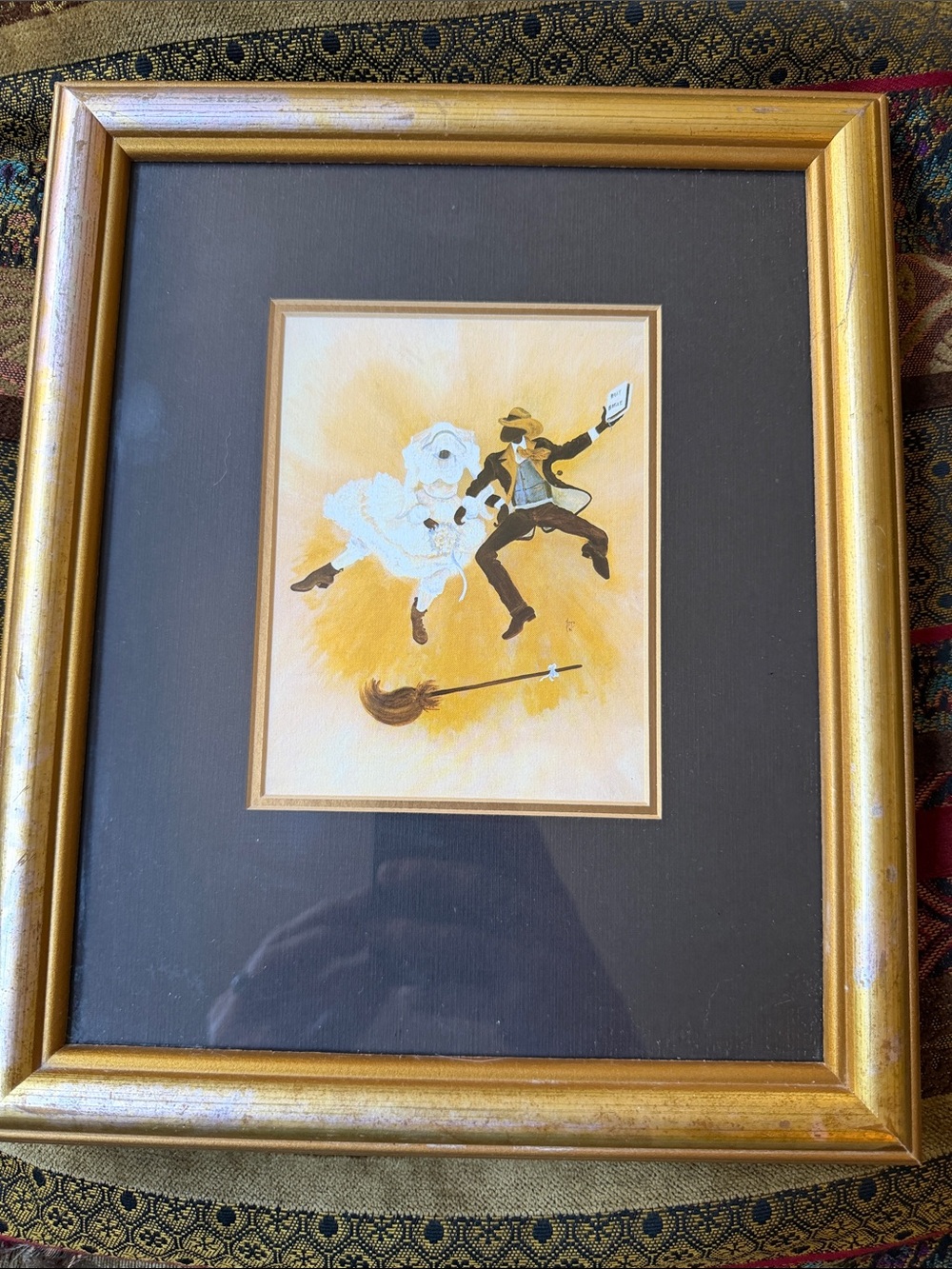 “Jumping The Broom” by Annie Lee framed at Samuel’s Gallery.